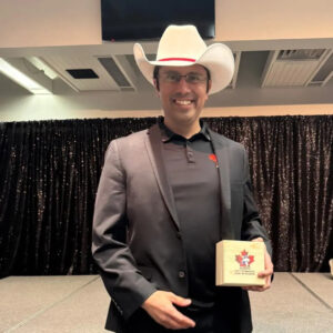Miguel Rueda posing with his award